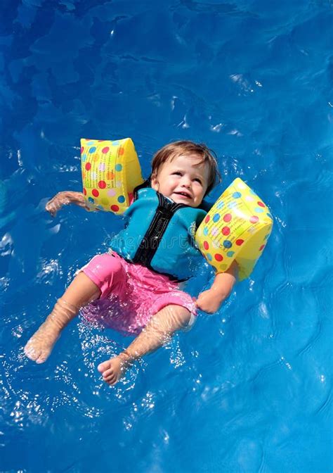 Baby girl in swimming pool stock image. Image of sunshine - 2965035