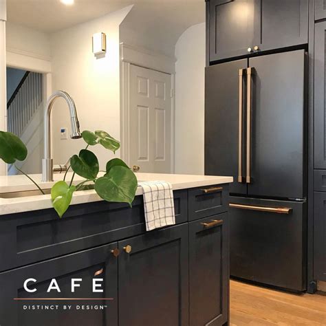 The moody dark cabinetry and matte black Café appliances are just ...