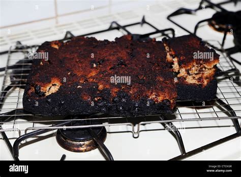 Burnt Cake On Rack On The Hob Stock Photo - Alamy