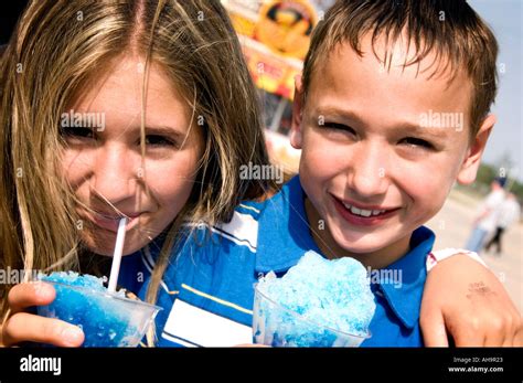 Kids eating carnival food Stock Photo - Alamy