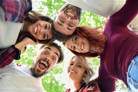 Free Photo | Friends in circle with heads together smiling