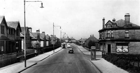 Old photograph of a shops, cars and houses on North Road in Bellshill, Glasgow , Scotland ...