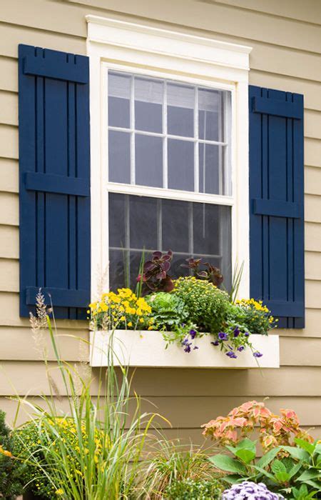 Navy House with Black Shutters: The Classic Combination You'll Love! Click Here to See Why.