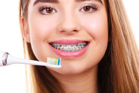 Woman Brushing Teeth with Braces Using Brush Stock Photo - Image of mouth, braces: 135101868