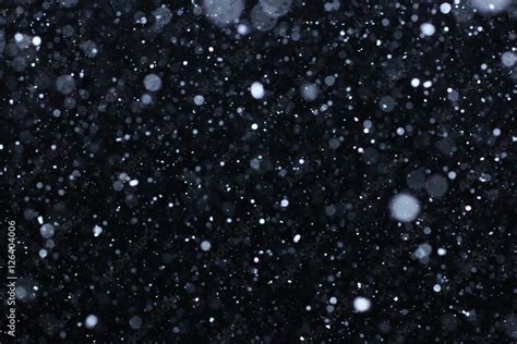 Real falling snow on a black background for use as a texture layer in your project. Add as ...