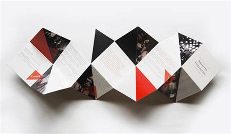 three folded brochures are shown on a white surface with red and black designs