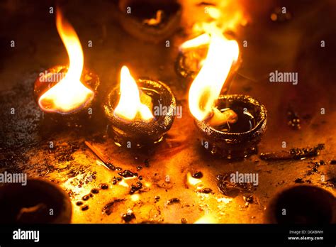 Burning oil lamps at religious temple. India Stock Photo - Alamy