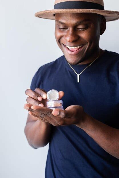 Premium Photo | African american man holds mineral facial powder for perfect makeup for women ...