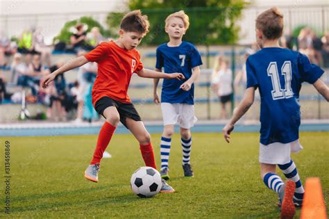 Young boys playing soccer game. Training and football match between ...