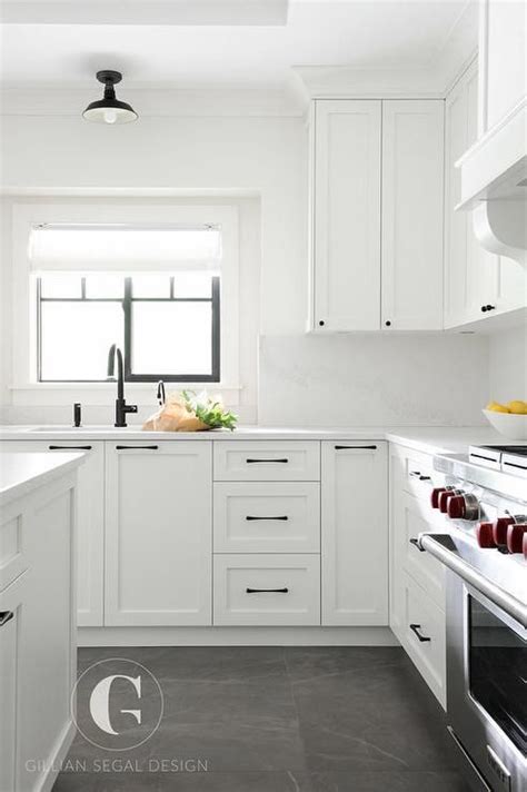 Gray tiles cover the floors of this beautiful black and white kitchen ...