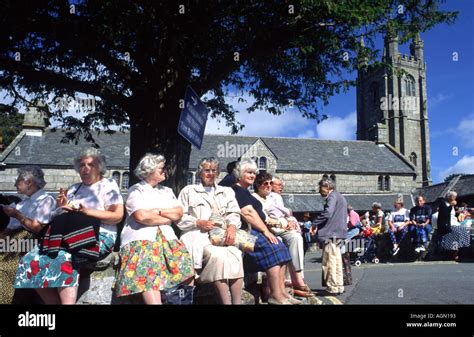 Ladies sitting outside Widecombe church at Widecombe in the moor Devon ...