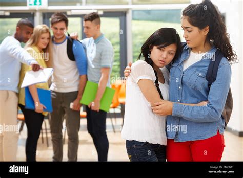 Friend Comforting Victim Of Bullying At School Stock Photo - Alamy