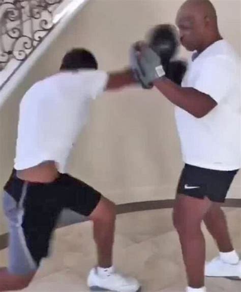 Mike Tyson trains his son in boxing as he hits pads