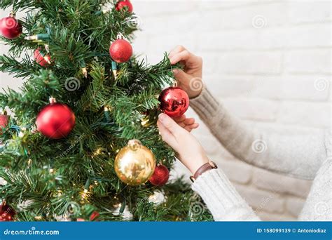 Woman Adorning Christmas Tree at Home Stock Image - Image of time, midsection: 158099139