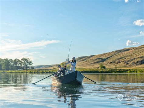 A group of anglers on a rowing boat on a clear lake on a sunny day in ...