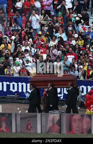 The casket holding the body of Mexican comedian Roberto Gomez Bolanos lies in an altar as a ...