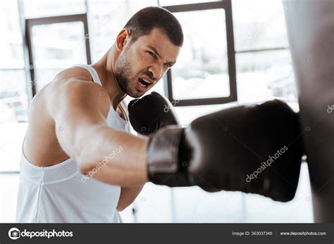 Selective Focus Angry Sportsman Boxing Gloves Exercising Punching Bag Stock Photo by ...