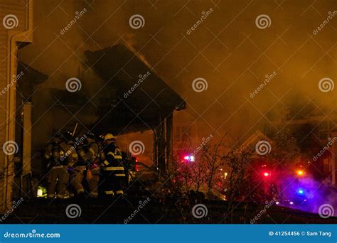 Firefighters Breaking into a Burning House Stock Photo - Image of burn ...