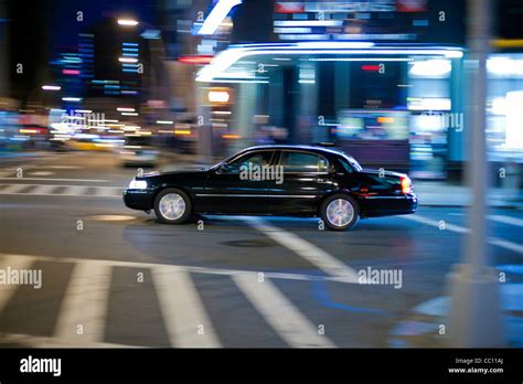 Black Limo at the crossroads. Manhattan street in the night Stock Photo - Alamy