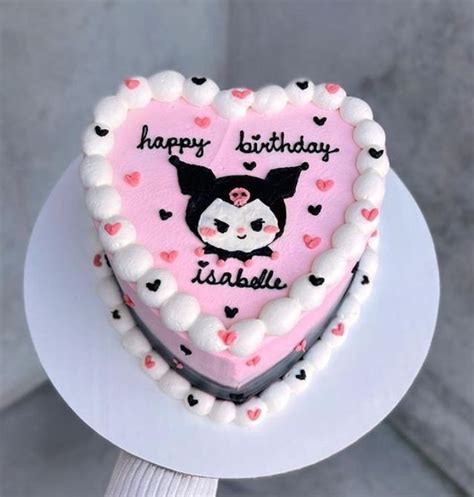 a heart shaped cake on a plate with the words happy birthday written in black and pink