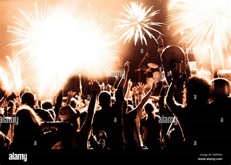 New Year concept - cheering crowd and fireworks Stock Photo - Alamy