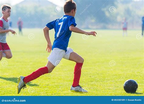 Boy kicking soccer ball stock image. Image of equipment - 85330189