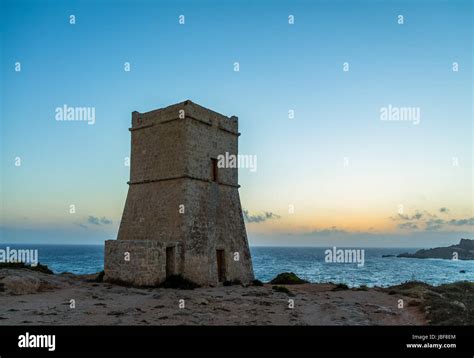 Ghajn Tuffieha Tower in Golden Bay at sunset - Malta Stock Photo - Alamy