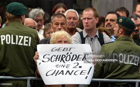 A supporter of German Chancellor Gerhard Schroeder displays a poster... News Photo - Getty Images