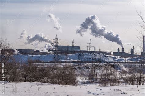 Pollution by pipes of industrial enterprises and factories. Industrial chimneys urban landscape ...