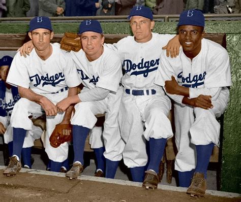 Jackie Robinson, who broke baseball's color barrier, alongside his Brooklyn Dodgers teammates in ...