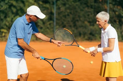 Premium Photo | Two people playing tennis on a court