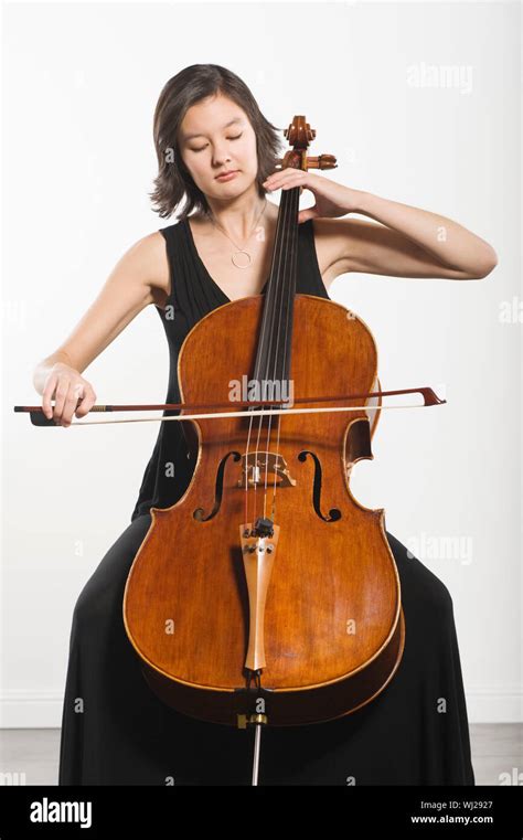 Beautiful young woman playing cello classical music instrument Stock ...