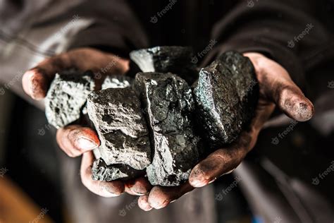 Premium Photo | Coal mining coal miner in the man hands of coal ...