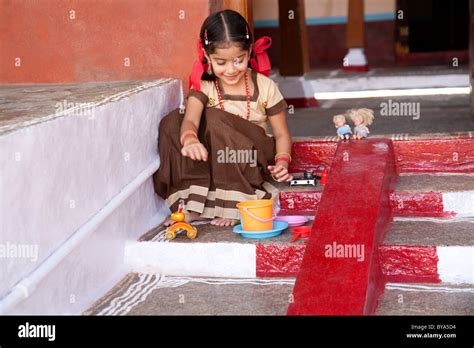 Little girl playing with her toys Stock Photo - Alamy