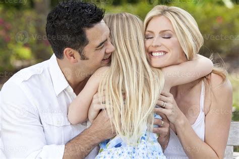 Girl Child Hugging Happy Parents In Park or Garden 854548 Stock Photo at Vecteezy