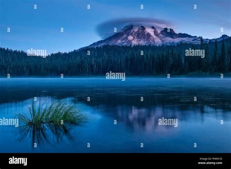 Mount Rainier with lenticular cloud at sunrise from Reflection Lake ...