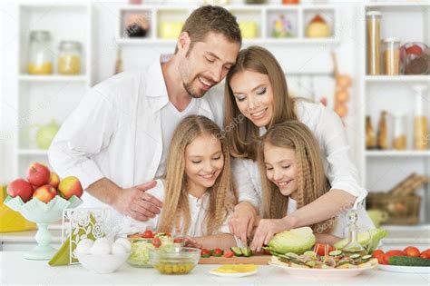 Happy family at kitchen Stock Photo by ©aletia 110408260