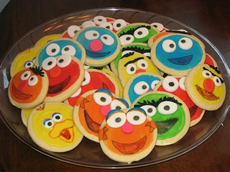 cookies decorated like sesame street characters are on a platter, ready to be eaten