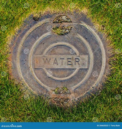 Water Manhole Cover In Grass Stock Photos - Image: 26663033