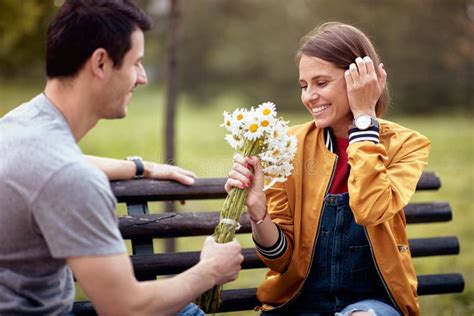 Man Giving Bouquet of Flowers To a Woman; Happy Couple Concept Stock Photo - Image of boyfriend ...