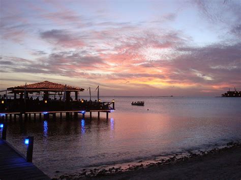 Pinchos Grill, Aruba. Bar and grill on a pier overlooking the crystal clear teal water of the ...