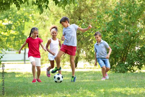 Kids Playing Soccer In The Park