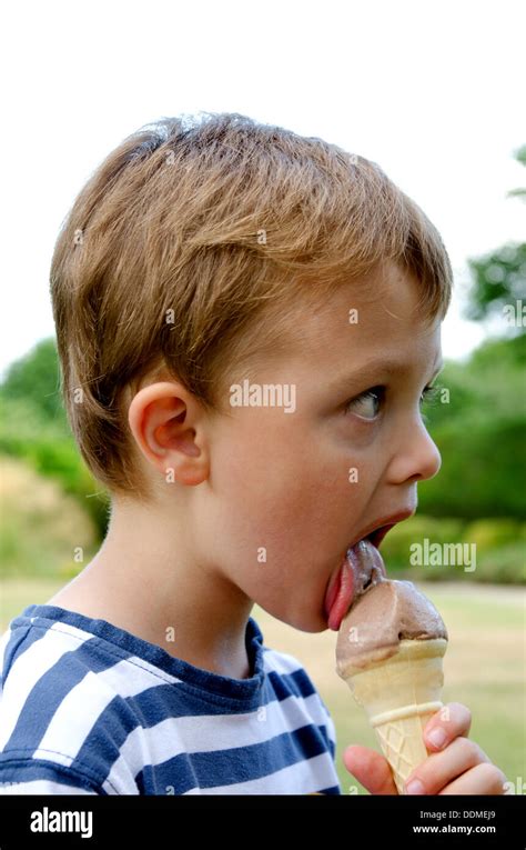 Boy licking icecream hi-res stock photography and images - Alamy