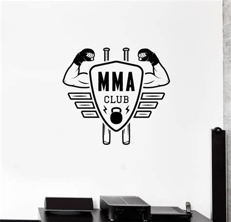 a wall decal that says mma club with two men holding their arms up