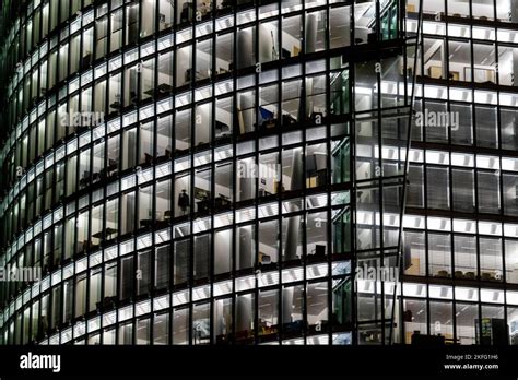 A modern building with a glass facade illuminated at night Stock Photo - Alamy