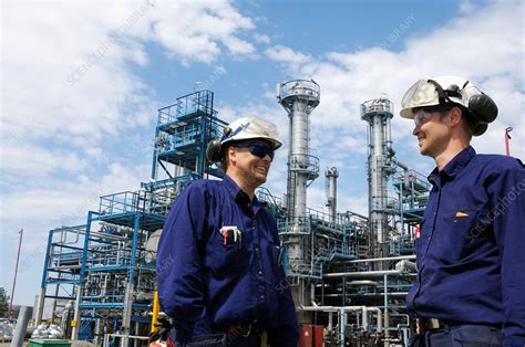 Oil and gas workers at refinery - Stock Image - F017/1991 - Science Photo Library