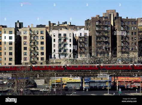 An elevated train passes tenement buildings in the Bronx New York Stock ...