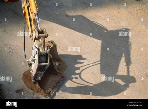 Hydraulic excavator arm fitted with breaker attachment Stock Photo - Alamy