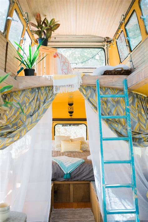 the interior of a small camper with curtains on it's sides and a ladder ...