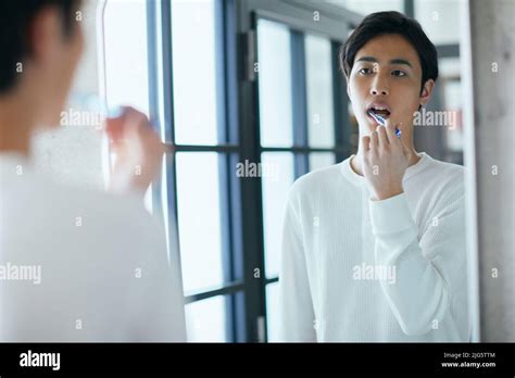 Japanese man brushing teeth Stock Photo - Alamy